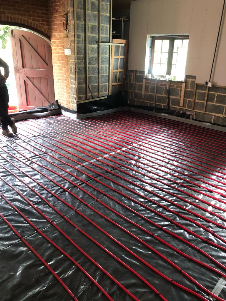Underfloor heating loops laid out and ready for the screed.